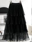 Black layered pleated skirt with stretch waistband and sheer tiered ruffle layers