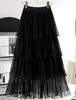 Black layered pleated skirt with stretch waistband and sheer tiered ruffle layers
