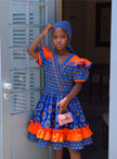 Kids’ blue floral traditional dress with orange ruffled sleeves and layered skirt hem