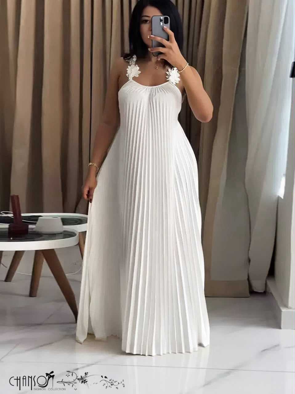 White pleated maxi dress with floral applique straps and open-back detailing
