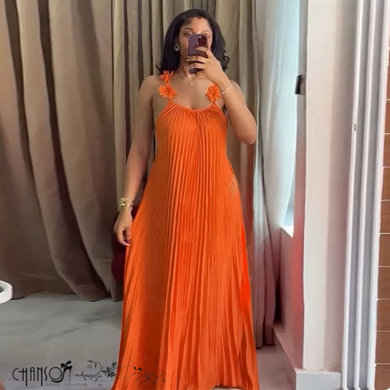Orange pleated maxi dress with floral applique bust and sleeveless halter neckline