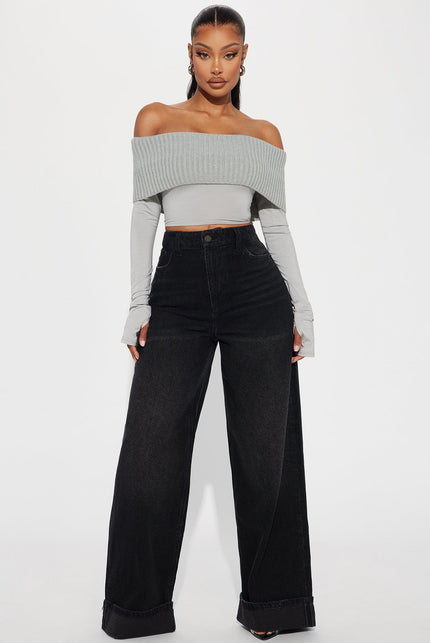 Black high-waist wide-leg jeans with cuff detail and relaxed straight silhouette