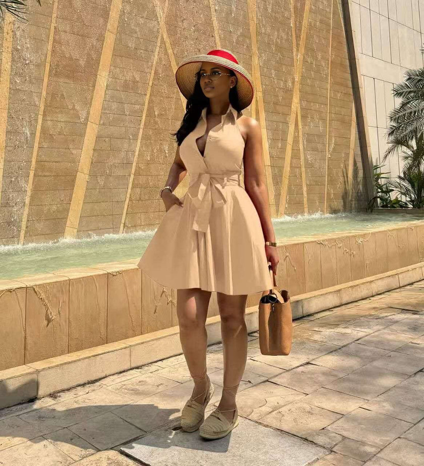 Nude sleeveless A-line dress with tie waist and flared skirt