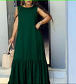 Dark green sleeveless maxi dress with ruffle hem and gathered skirt.
