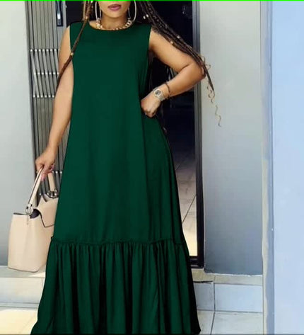 Dark green sleeveless maxi dress with ruffle hem and gathered skirt.
