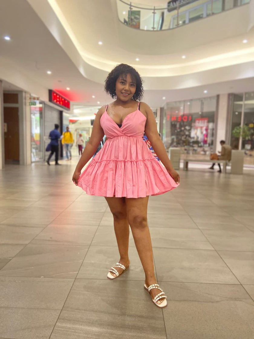 Pink ruffle V-neck mini dress with adjustable spaghetti straps, tiered skirt