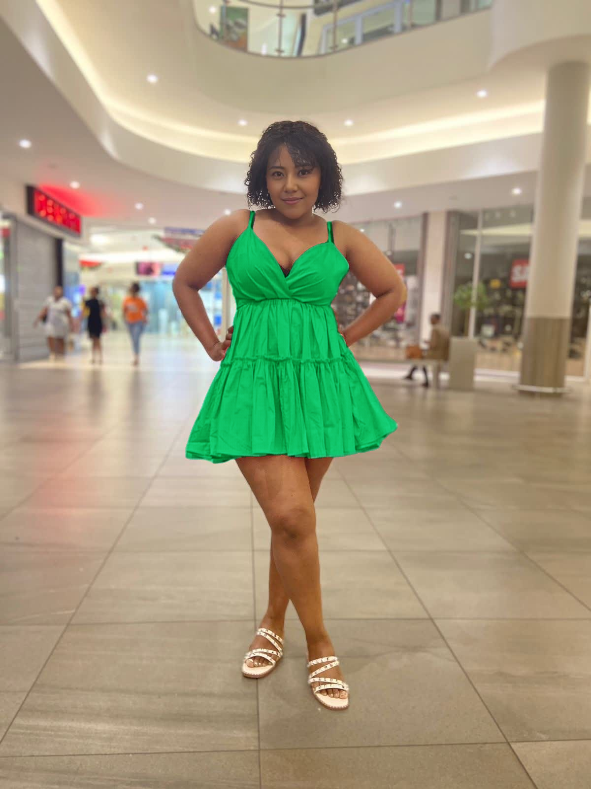 Green ruffle V-neck mini dress with adjustable spaghetti straps, layered tiers
