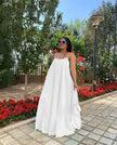 White maxi dress with adjustable spaghetti straps, sleeveless, gathered flared skirt