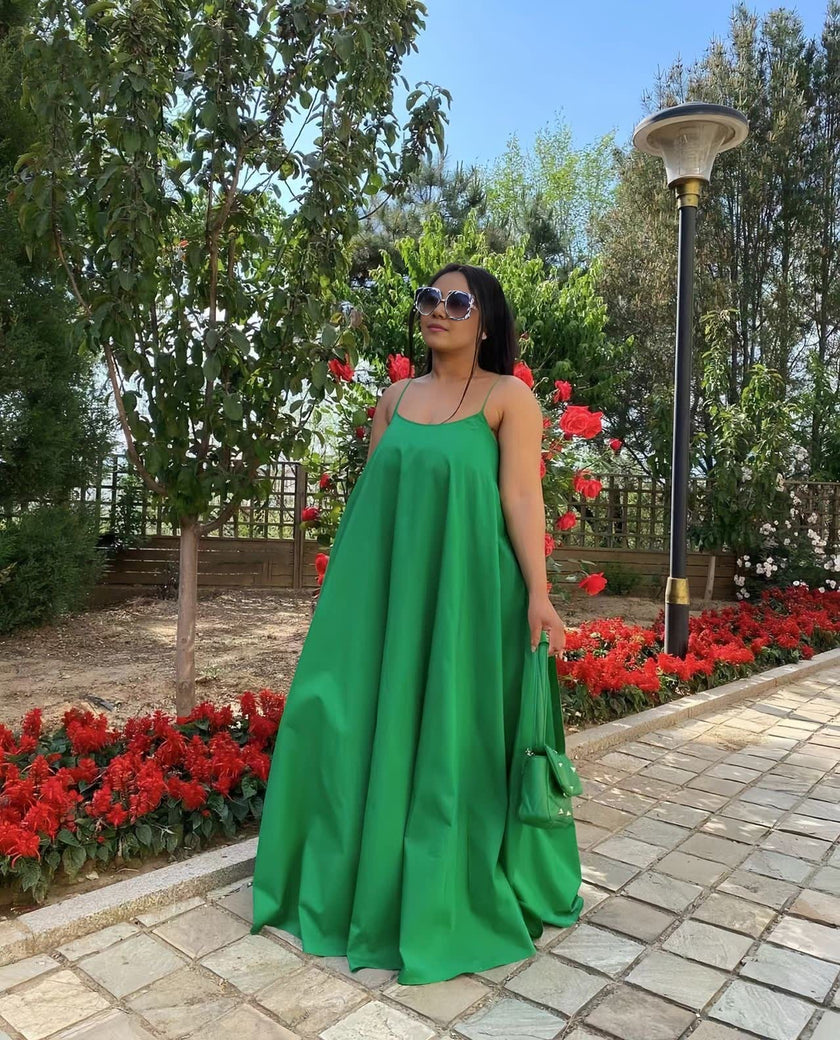 Green maxi dress with adjustable spaghetti straps, sleeveless, gathered flared skirt