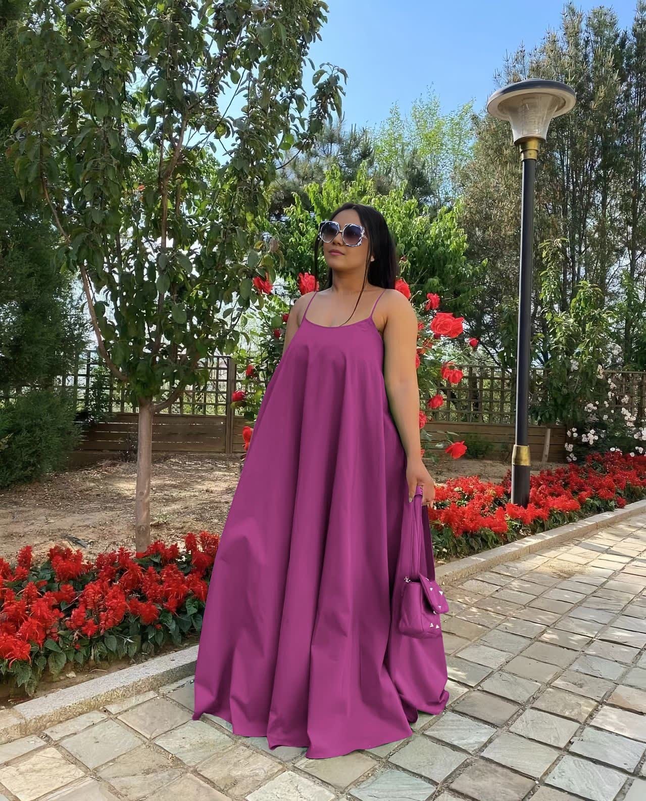 Purple maxi dress with adjustable spaghetti straps, sleeveless, gathered flared skirt