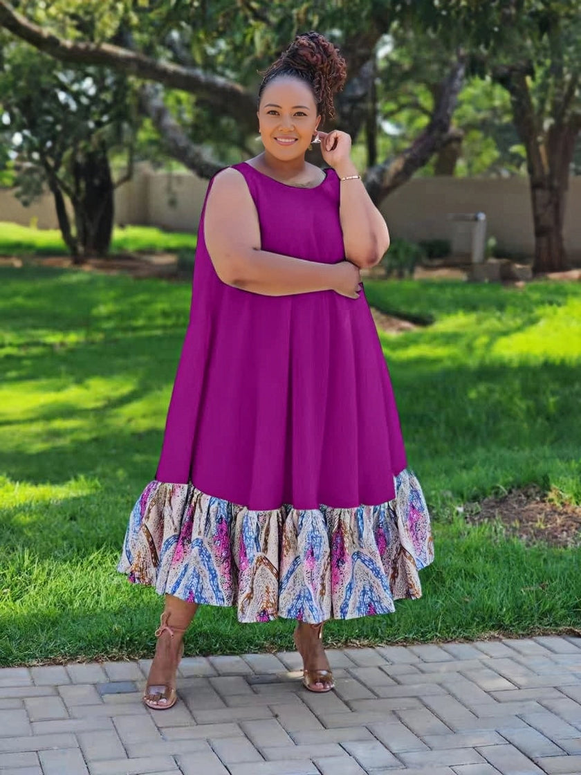 Plus size sleeveless midi dress with purple bodice and colorful ruffle hem