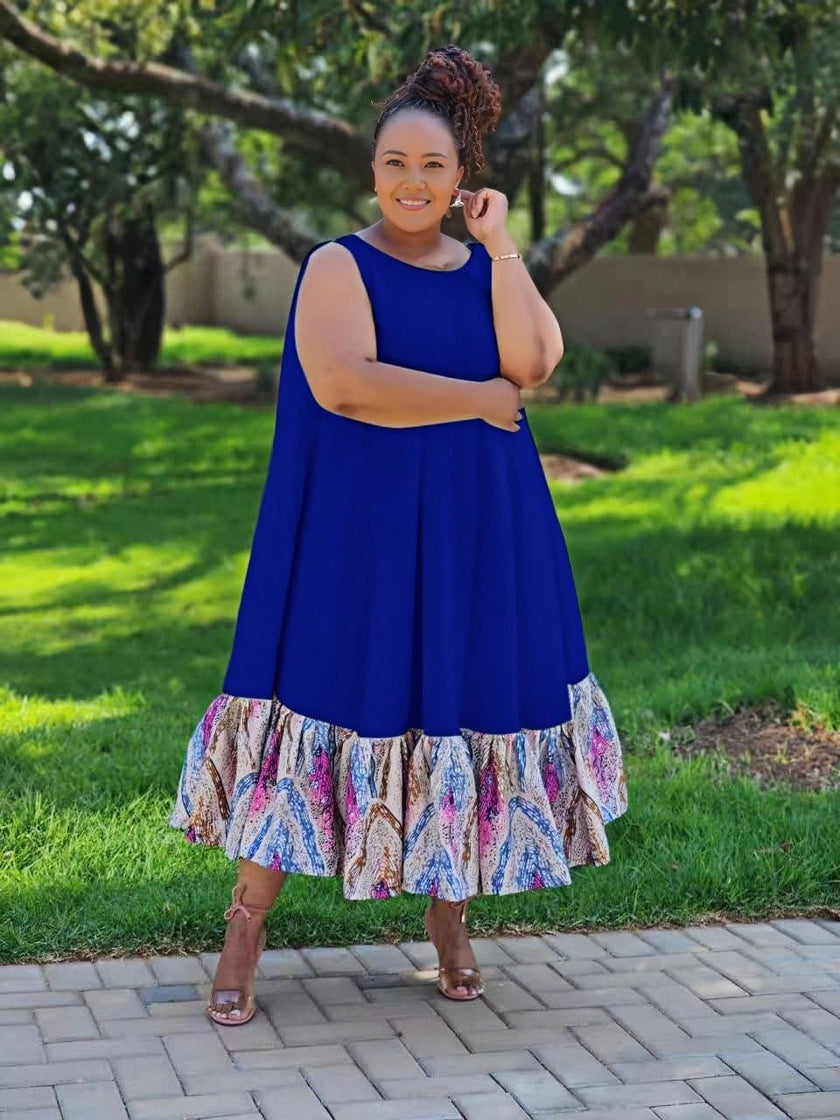 Plus size sleeveless midi dress with blue bodice and colorful ruffle hem