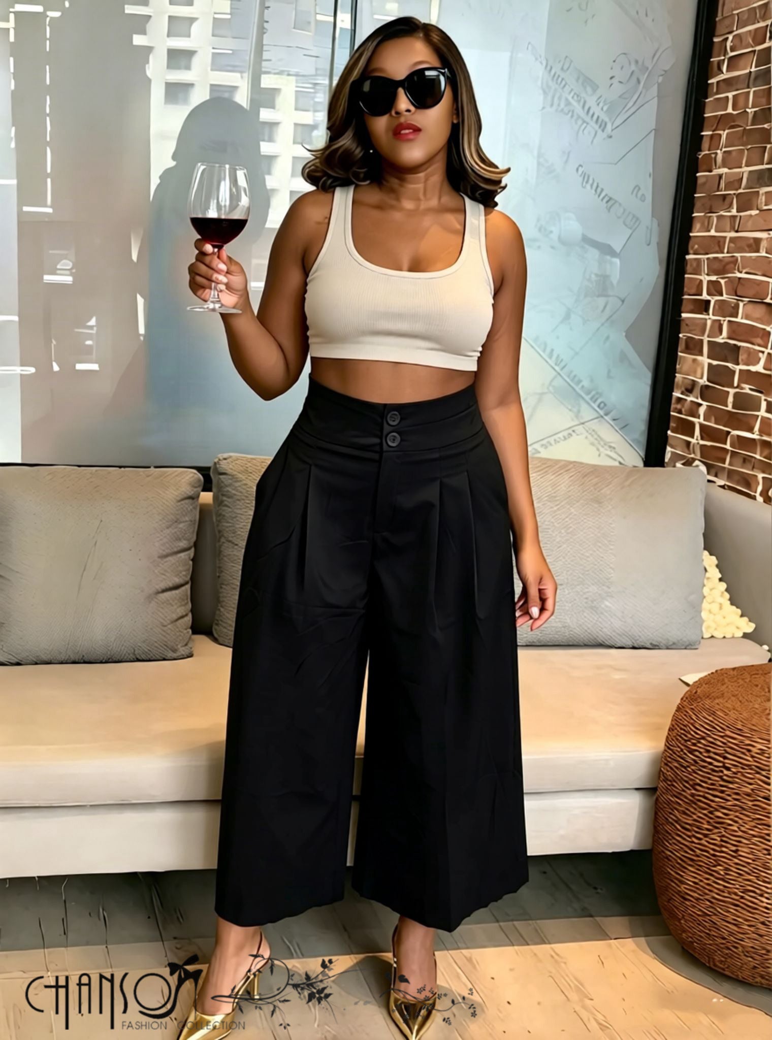 Black pleated wide-leg culottes with stretch waistband and button front.