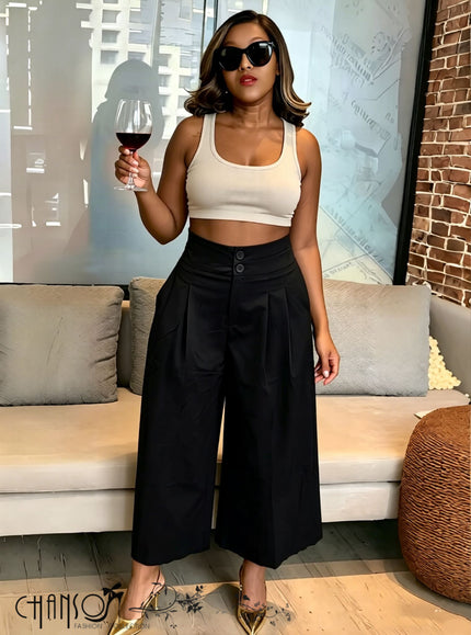 Black pleated wide-leg culottes with stretch waistband and button front