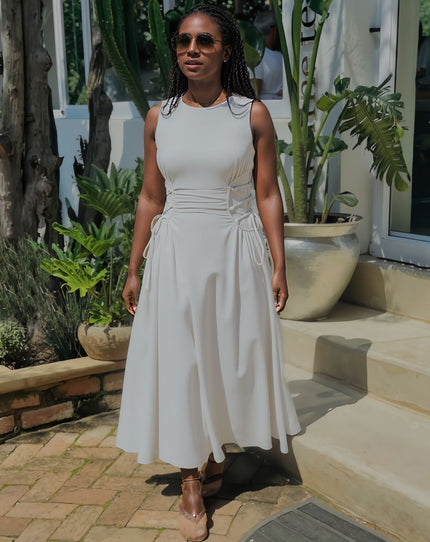 White sleeveless midi dress with side ruching and gathered skirt