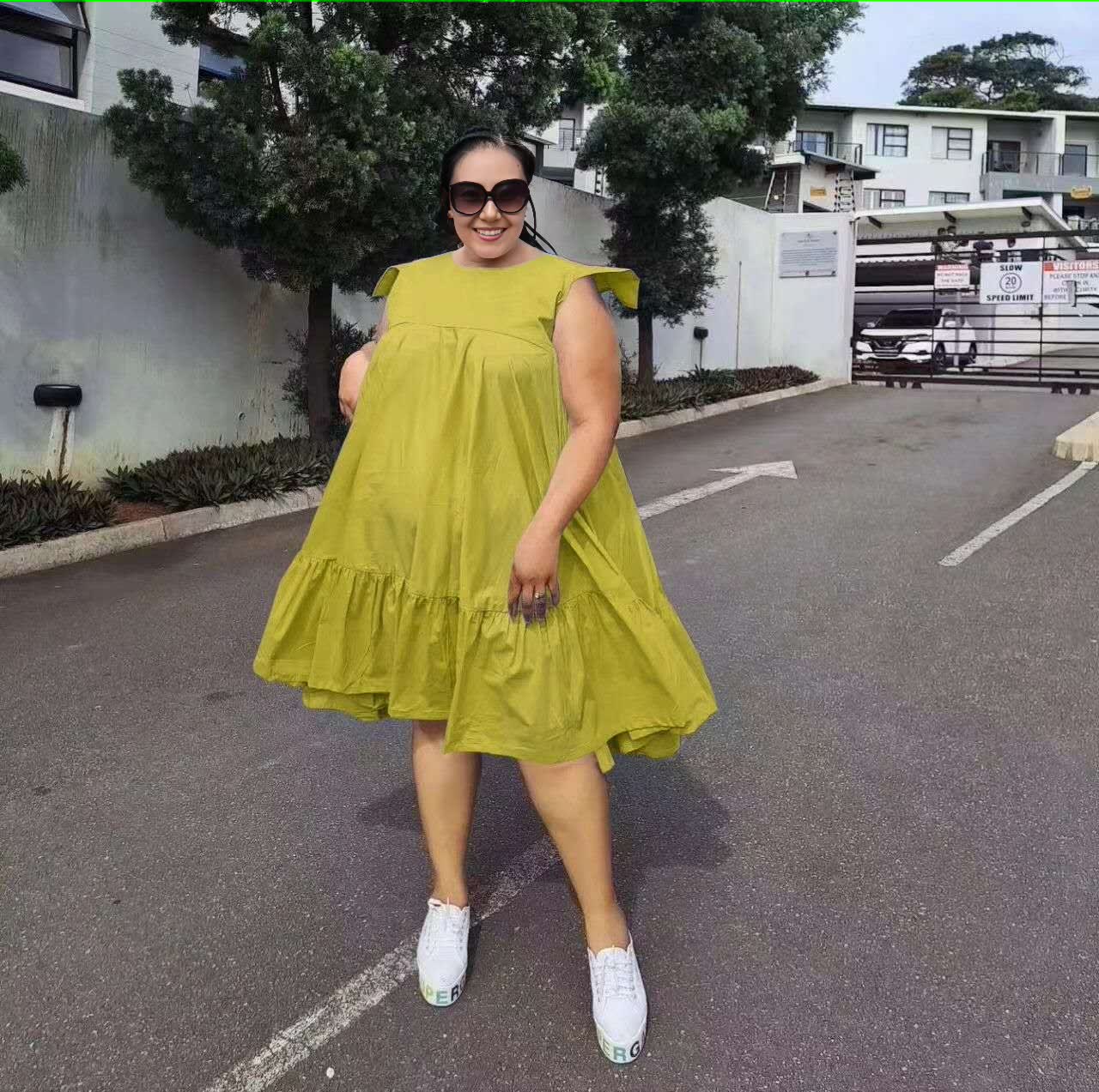 Yellow sleeveless A-line dress with ruffle hem and tiered skirt