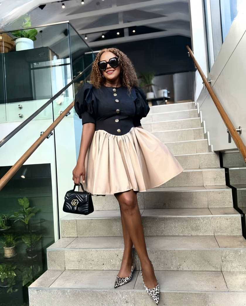 Black puff-sleeve mini dress with buttoned bodice and cream high-waist skirt
