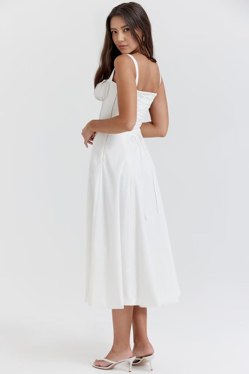 White midi dress with ruched bodice, thin straps, and gathered skirt