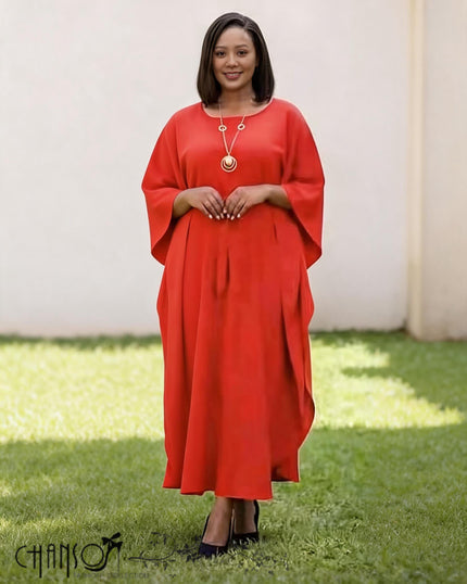 Red loose-fit midi dress with batwing sleeves and round neckline, small button detail