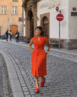 Sleeveless midi utility dress, orange-red with front seams and pockets