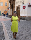 Sleeveless midi utility dress, bright lime green with front seams and pockets