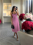 Striped knit midi dress with black vertical stripes on pink, sleeveless scoop neck