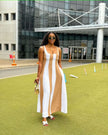 Sleeveless maxi dress with white vertical stripes over brown paneling, wide scoop neck