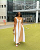 Sleeveless maxi dress with white vertical stripes over brown paneling, wide scoop neck