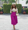 Pleated A-line midi skirt with stretch waistband and front drape panel in burlywood