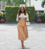 Pleated A-line midi skirt with stretch waistband and front drape panel in black