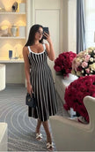 Striped knit midi dress with white vertical stripes on black, sleeveless