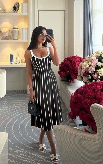 Striped knit midi dress with white vertical stripes on black, sleeveless