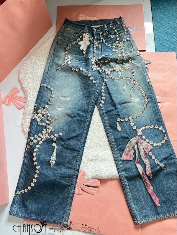 Distressed blue wide-leg jeans with rhinestone chain embroidery and ribbon tassel