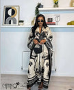Kaftan dress with black-and-cream tropical bird and palm print, wide sleeves