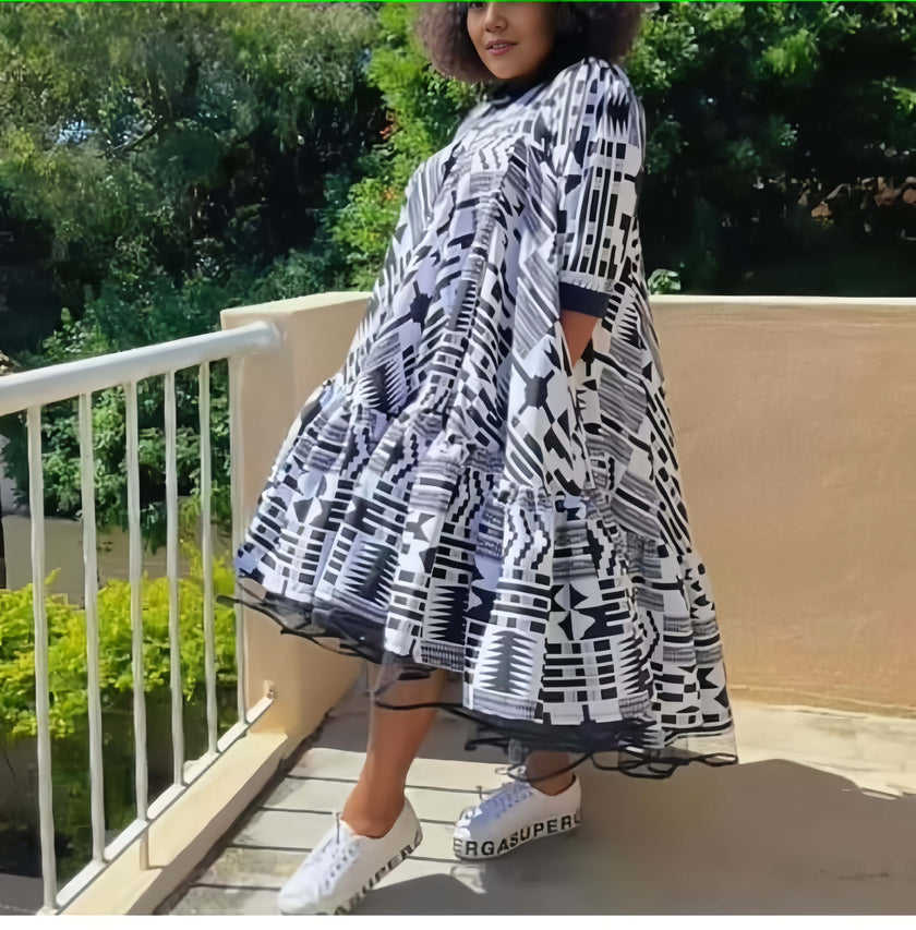 Plus size geometric print dress with flared skirt and short sleeves, black and white.
