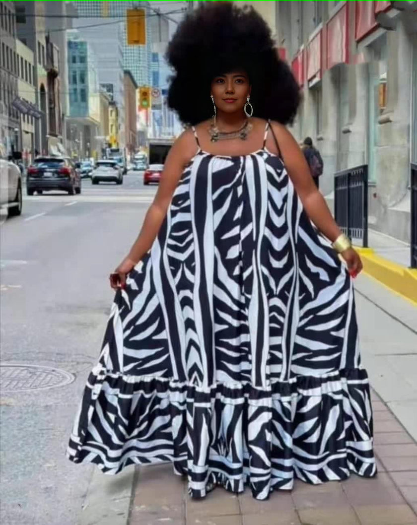Plus size maxi dress with black-and-white animal stripe print, ruffle trim, spaghetti straps