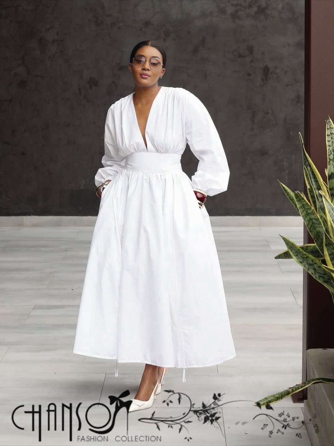 V-neck midi dress in white with puff sleeves and cinched waist, full gathered skirt