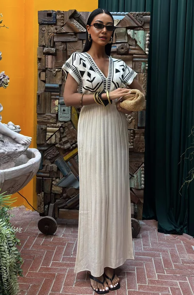 Cream knit maxi dress with black geometric V yoke and pleated skirt
