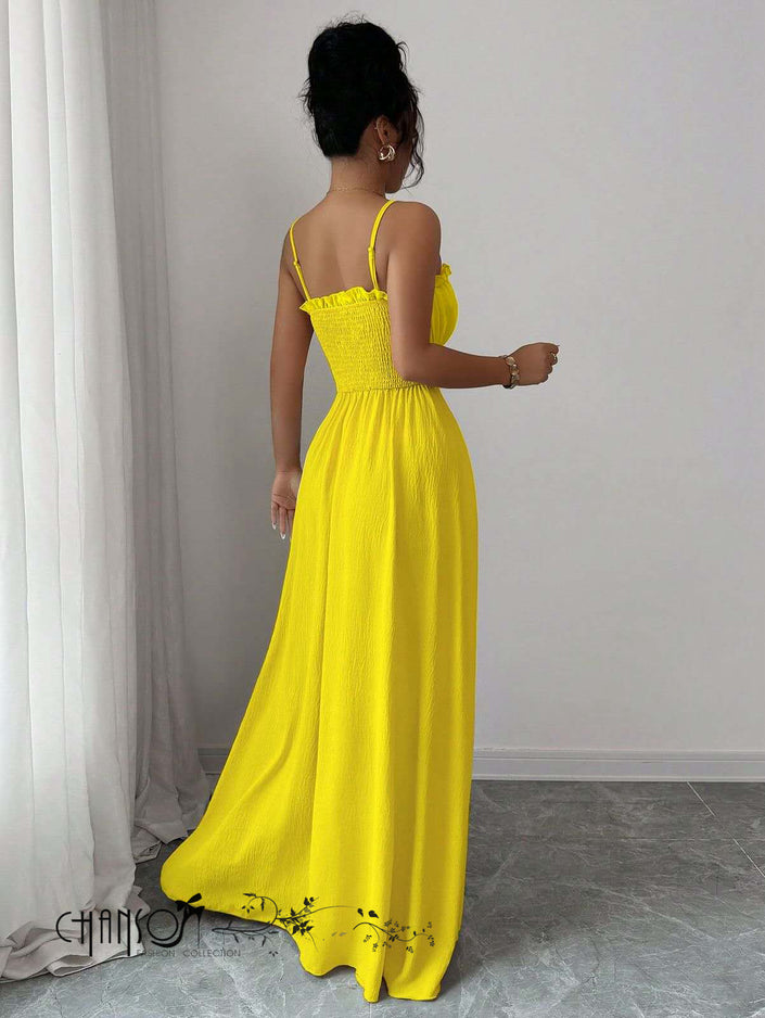 Yellow pleated maxi dress with thin straps and ruched bodice, long flowy skirt