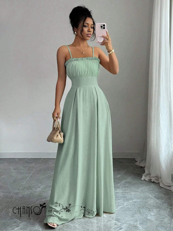 Mint-green pleated maxi dress with thin straps, ruched bodice, and lace-trim hem