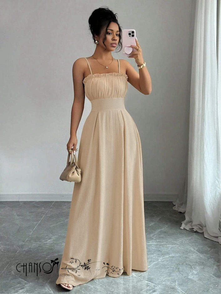 Tan pleated maxi dress with thin straps, ruched bust, and embroidered lace hem