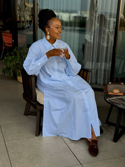 Light blue loose-fit maxi shirt dress with collar, long sleeves, and side patch pockets