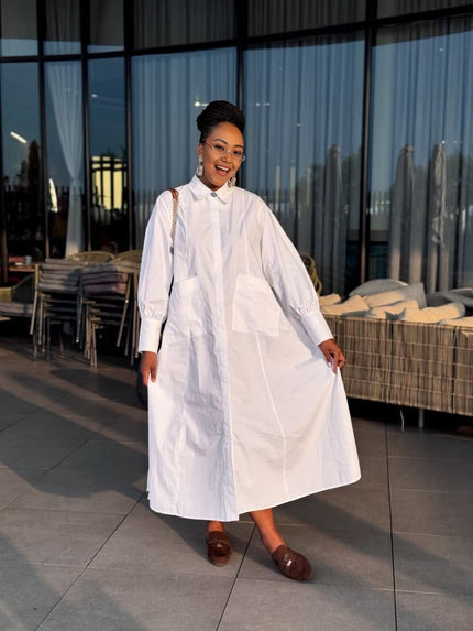 White loose-fit maxi shirt dress with collar, long sleeves, and side patch pockets