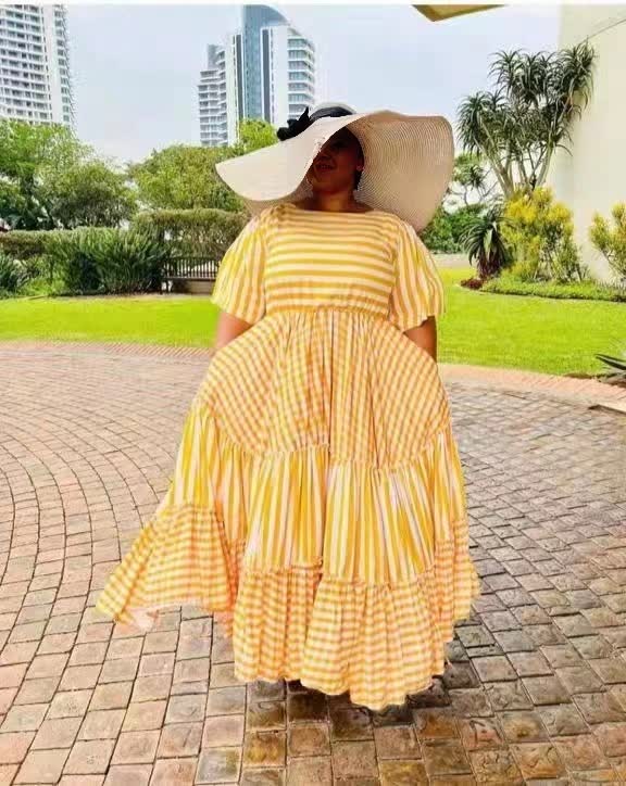 Plus size yellow-and-white striped maxi dress with tiered ruffle skirt