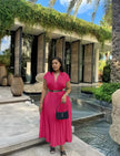 Hot-pink pleated midi dress with belted waist, V-neck and short sleeves.