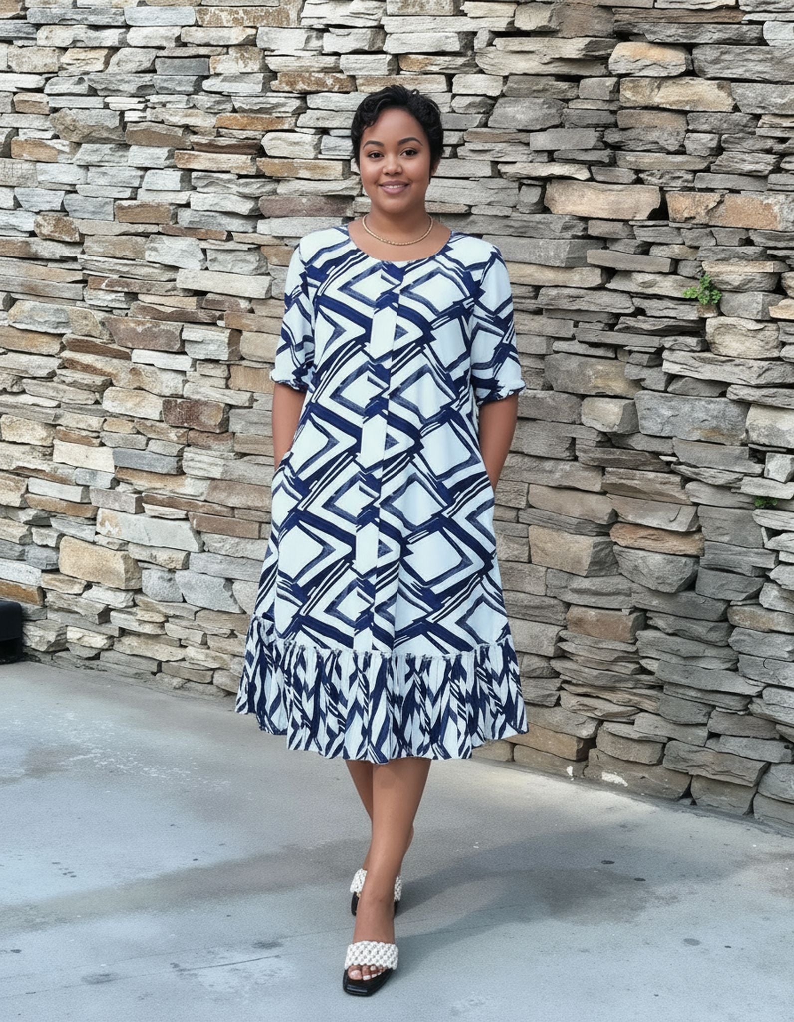 Plus size midi dress with navy-and-white geometric print and ruffle hem