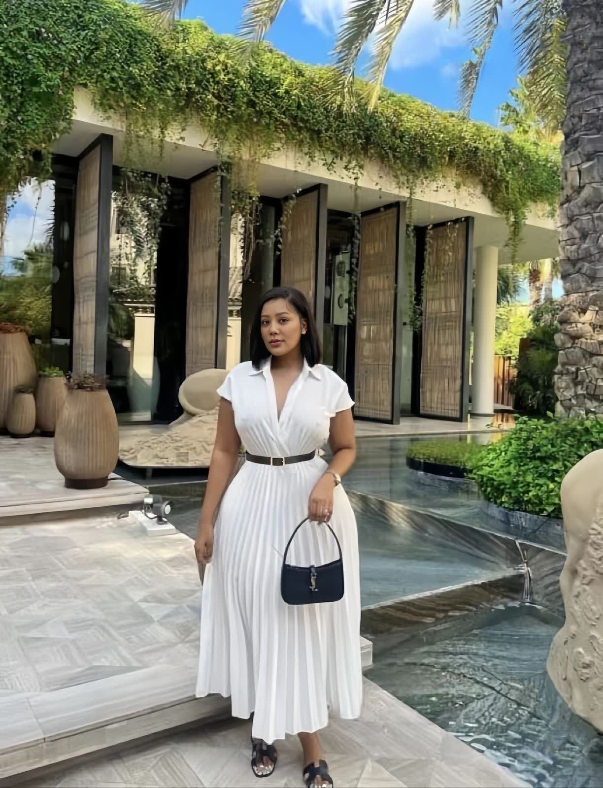 White pleated midi dress with belted waist, V-neck and short sleeves.