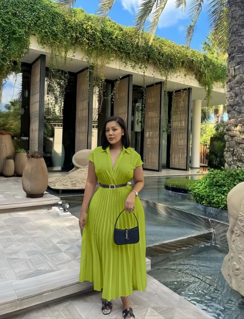 Yellow-green pleated midi dress with belted waist, V-neck and short sleeves.