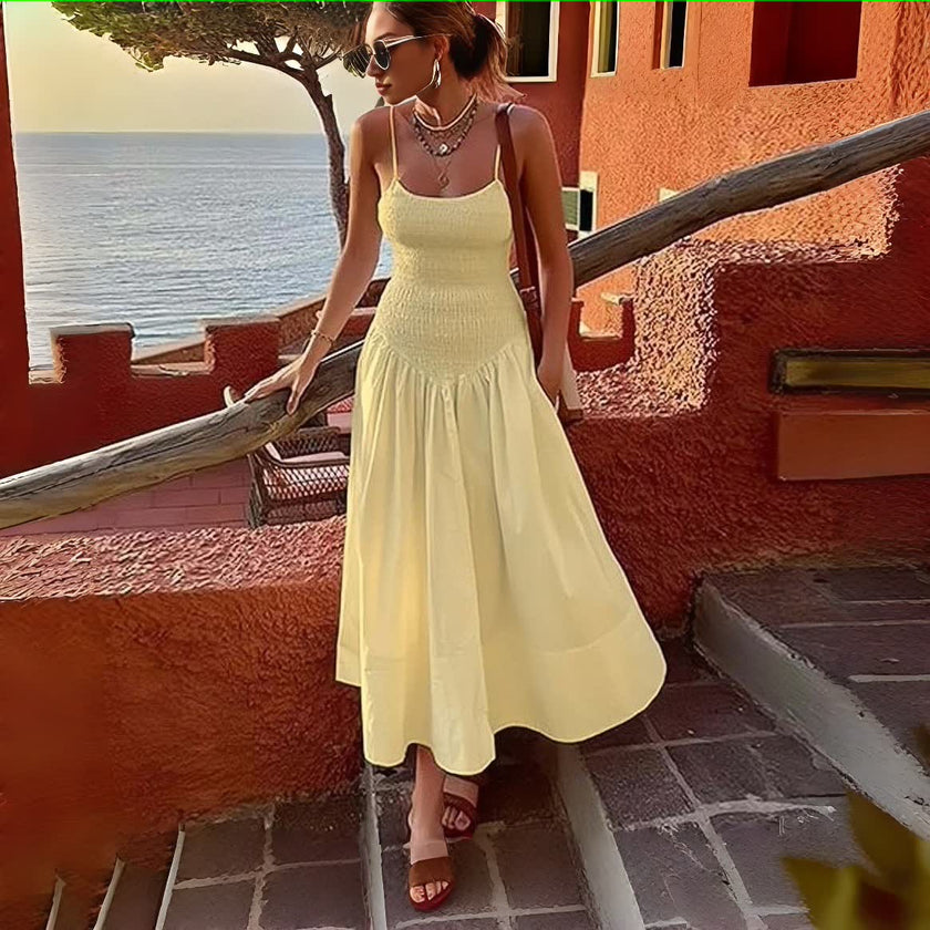 Cream sleeveless dress with smocked bodice and flared skirt
