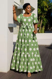 Tiered polka dot midi dress in mint green with white spots, short sleeves, belted waist